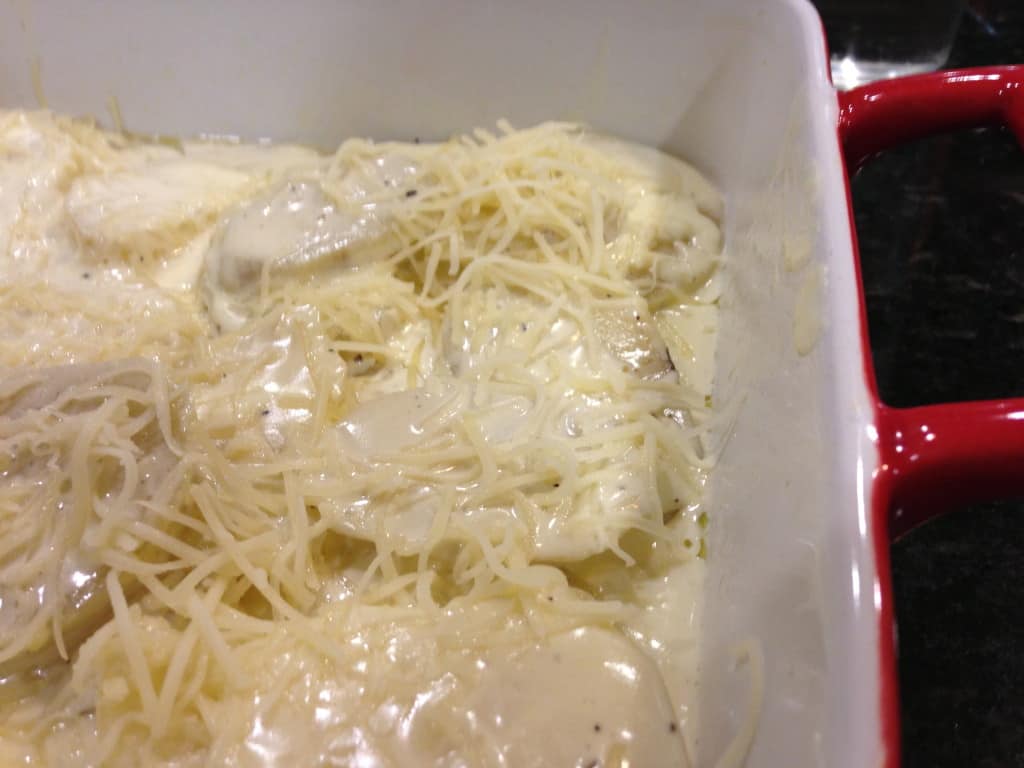 layering potatoes and cheese for scalloped potatoes