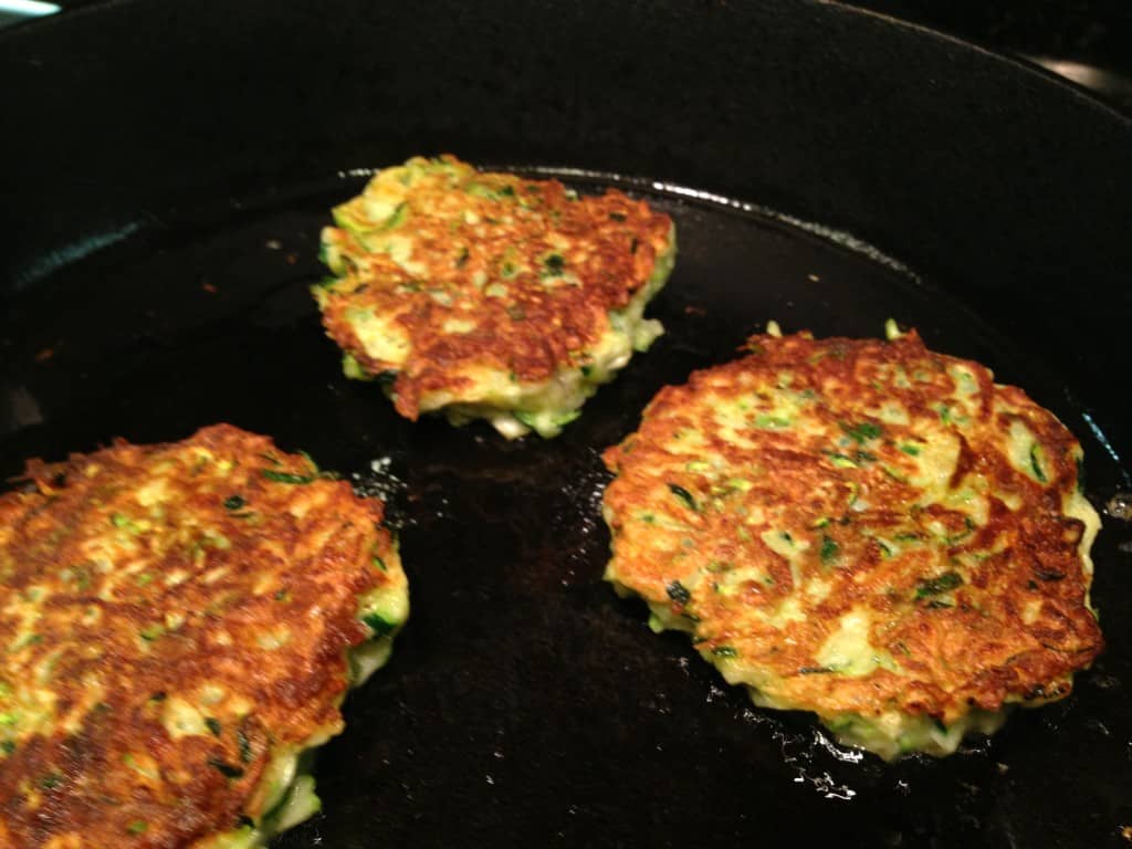 Zucchini fritters in the frying pan.