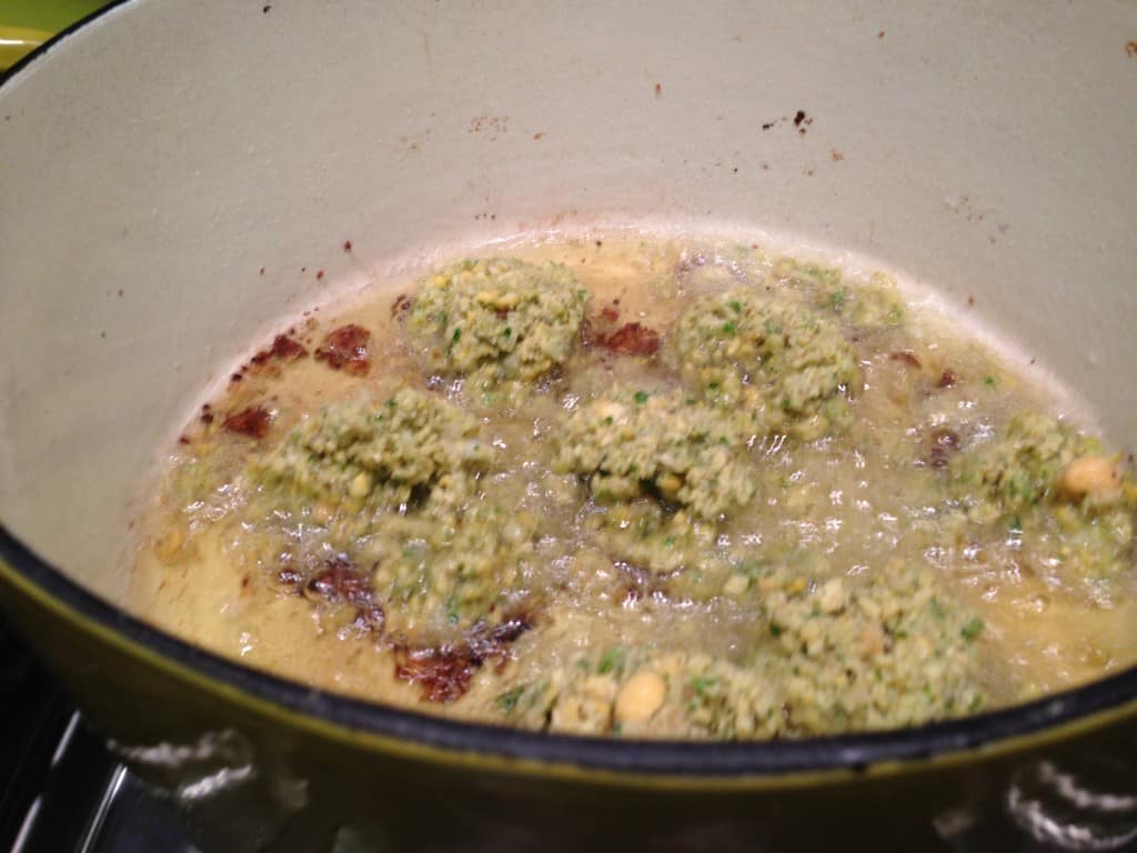 Frying a batch of falafel.